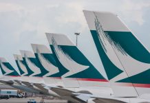 Kini Penumpang Cathay Pacific Wajib Kenakan Masker Selama Perjalanan